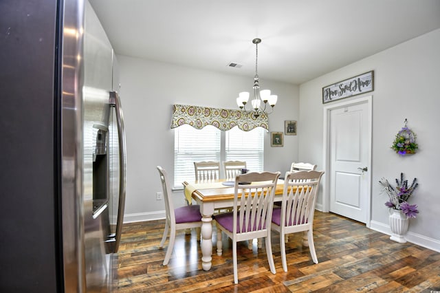 dining area with a notable chandelier and dark hardwood / wood-style flooring