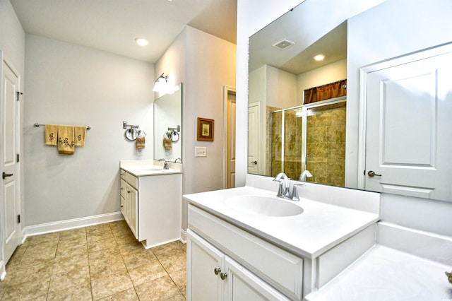 bathroom featuring vanity and a shower with door