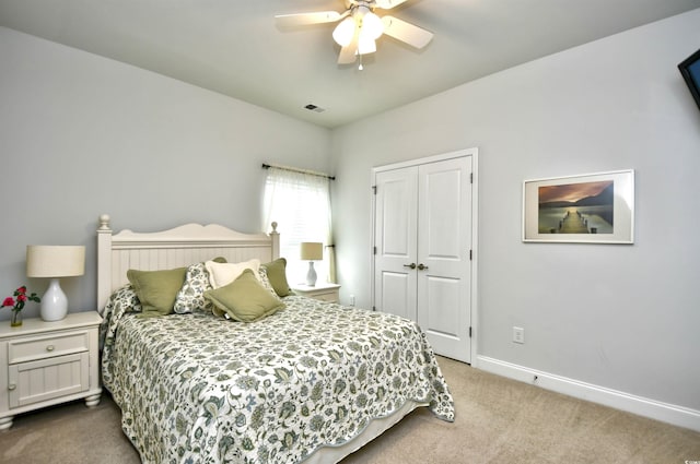 carpeted bedroom with a closet and ceiling fan