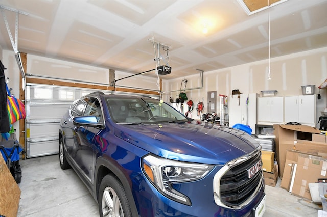 garage featuring electric panel and a garage door opener