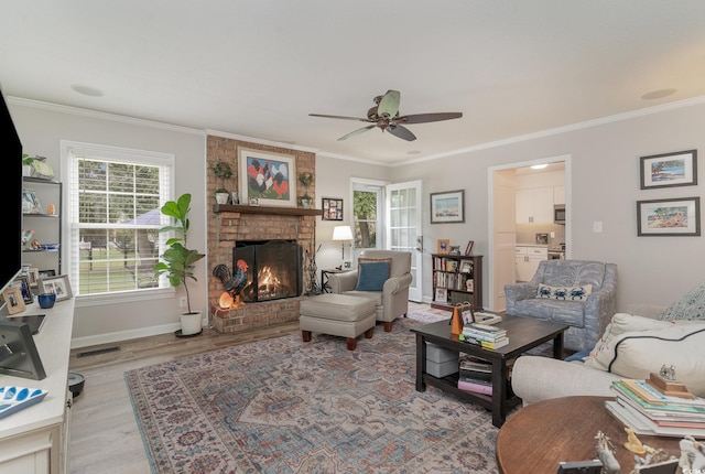 living room with light hardwood / wood-style flooring, a fireplace, and crown molding