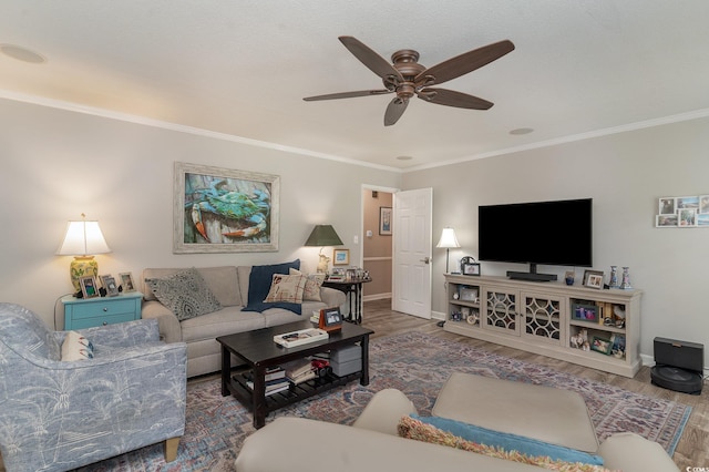 living room featuring ornamental molding, hardwood / wood-style floors, and ceiling fan