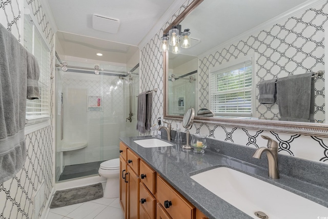 bathroom featuring toilet, a shower with shower door, vanity, crown molding, and tile patterned floors