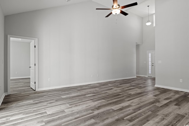 unfurnished living room featuring ceiling fan, high vaulted ceiling, and light hardwood / wood-style flooring