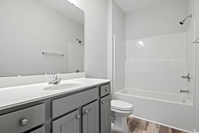 full bathroom featuring vanity, hardwood / wood-style floors, bathing tub / shower combination, and toilet