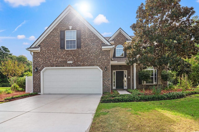 front of property with a front yard and a garage