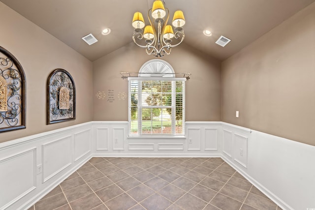 unfurnished room with light tile patterned flooring, vaulted ceiling, and an inviting chandelier