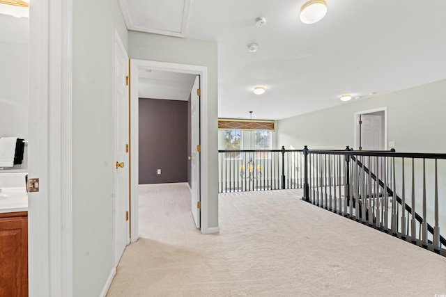 hall with light colored carpet