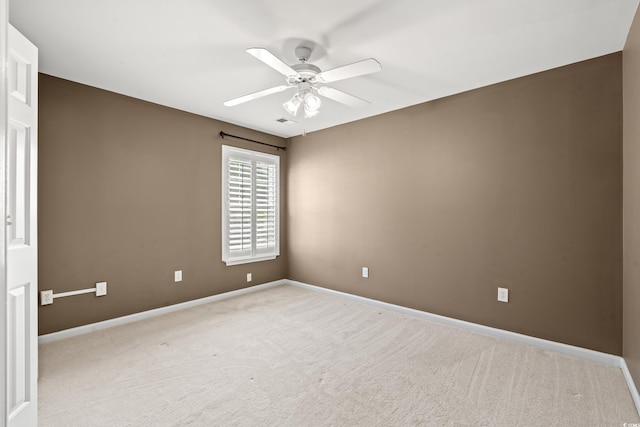 carpeted spare room with ceiling fan