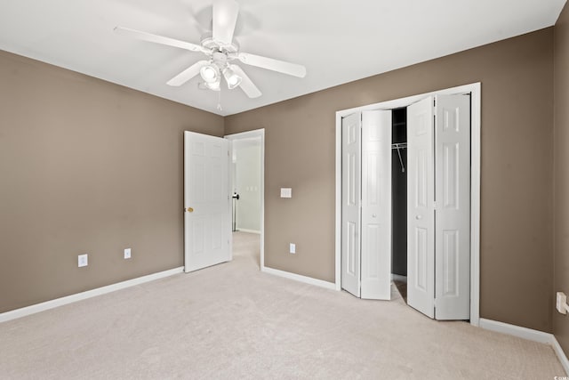 unfurnished bedroom featuring a closet, ceiling fan, and light colored carpet