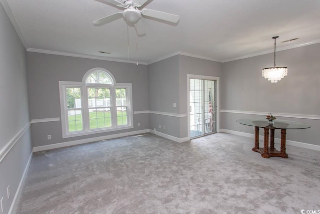 unfurnished room with ornamental molding, carpet floors, and ceiling fan with notable chandelier