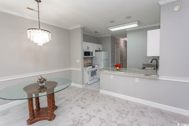 kitchen featuring light carpet, kitchen peninsula, white cabinetry, sink, and white appliances