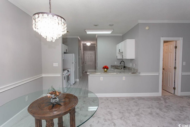 kitchen with kitchen peninsula, white cabinetry, crown molding, light colored carpet, and white appliances