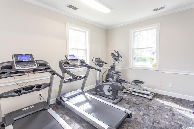 workout room featuring crown molding