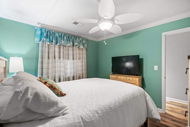 bedroom featuring ornamental molding, ceiling fan, and hardwood / wood-style flooring