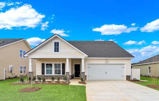 view of front of property with a front yard, a porch, and a garage