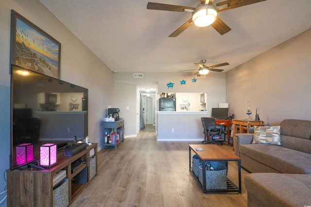 living room with wood-type flooring and ceiling fan