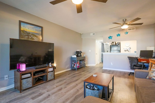 living room featuring ceiling fan and wood-type flooring