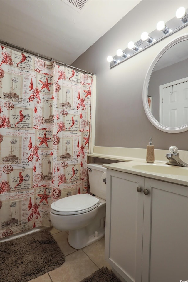 bathroom featuring walk in shower, vanity, tile patterned flooring, and toilet