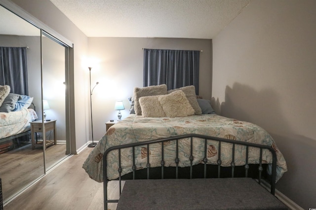 bedroom featuring a textured ceiling, a closet, and hardwood / wood-style floors