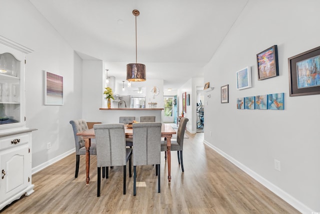 dining room featuring light wood-type flooring and sink