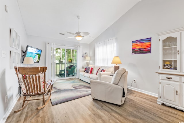 living room featuring light wood-type flooring, ceiling fan, and high vaulted ceiling