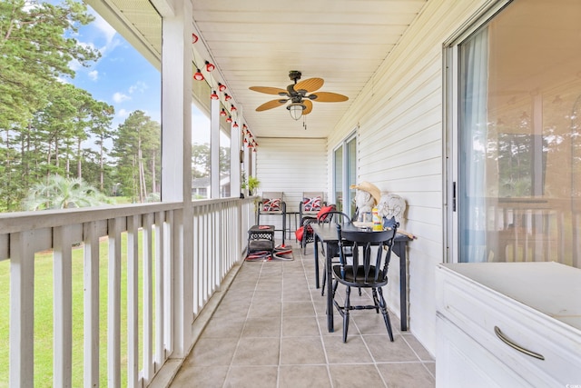 sunroom / solarium with ceiling fan and wooden ceiling