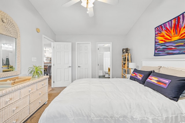 carpeted bedroom with ceiling fan, connected bathroom, and vaulted ceiling