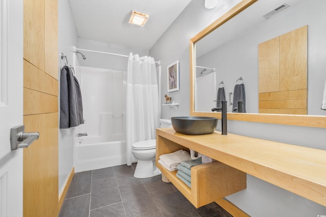 full bathroom with vanity, toilet, a textured ceiling, tile patterned flooring, and shower / tub combo with curtain