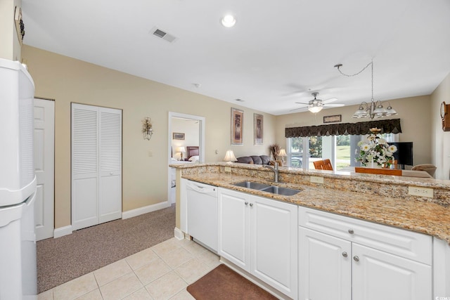 kitchen with white cabinets, white appliances, ceiling fan, sink, and light colored carpet