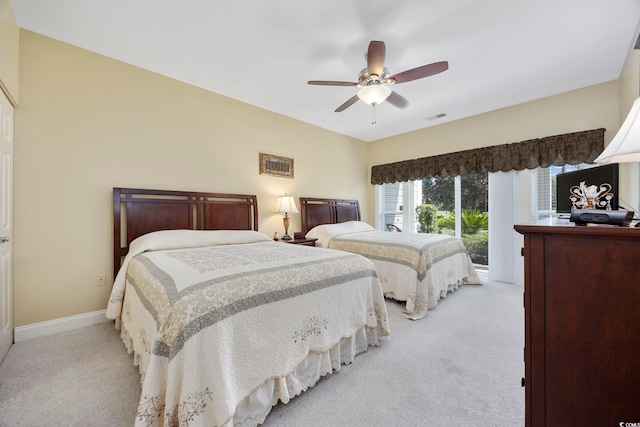 carpeted bedroom with ceiling fan and access to outside