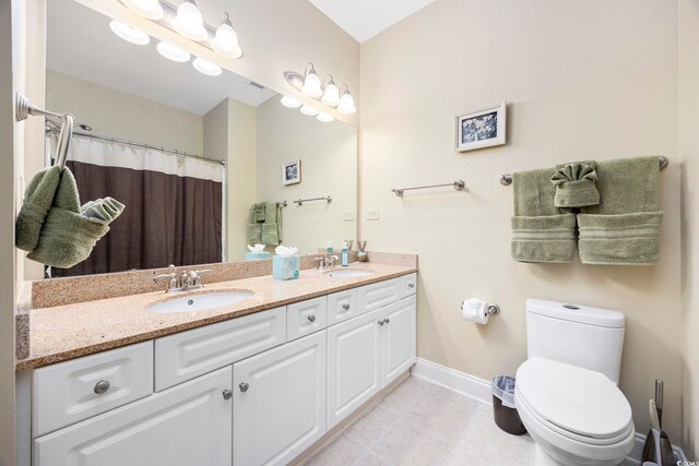 bathroom with tile patterned floors, a shower with curtain, vanity, and toilet