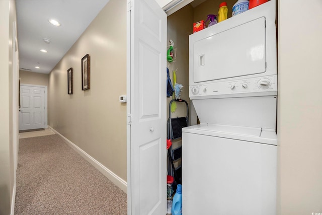 washroom with carpet and stacked washer and dryer