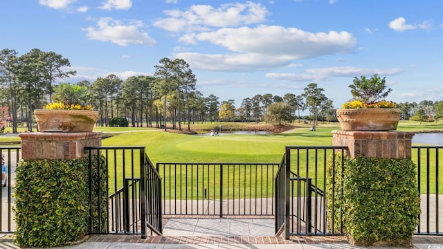 view of gate with a yard