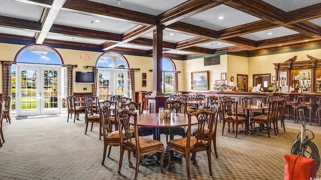 carpeted dining space with coffered ceiling, beamed ceiling, french doors, and a wealth of natural light