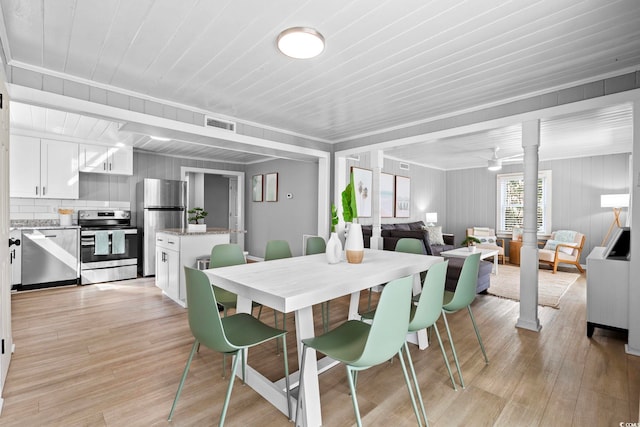 dining room with wood ceiling, light hardwood / wood-style floors, ornamental molding, and ornate columns