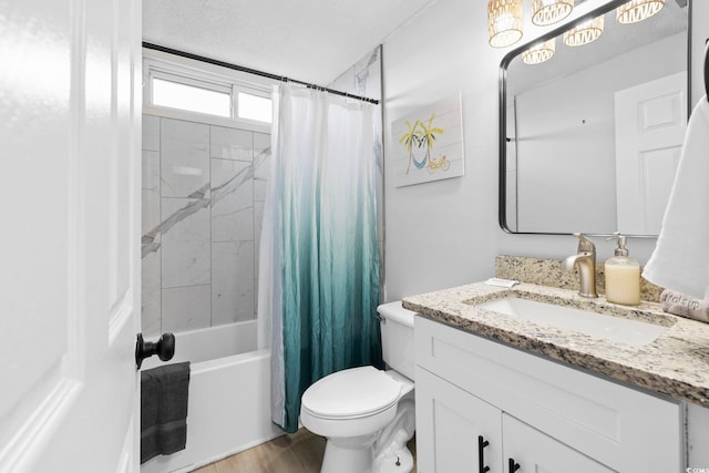 full bathroom featuring vanity, toilet, a textured ceiling, hardwood / wood-style floors, and shower / tub combo with curtain