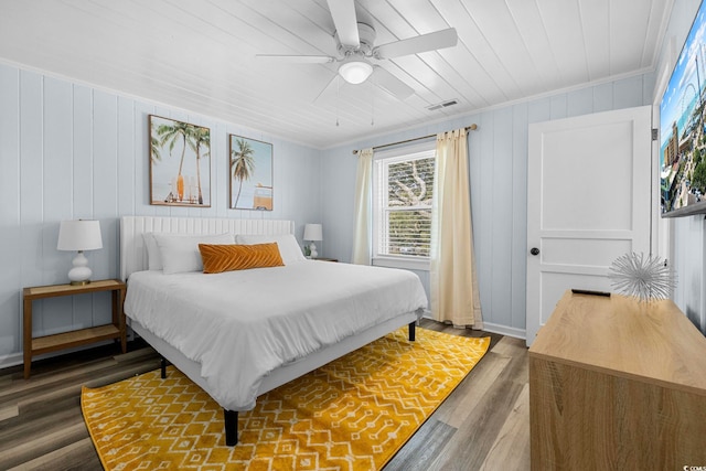 bedroom with ceiling fan, hardwood / wood-style flooring, and ornamental molding