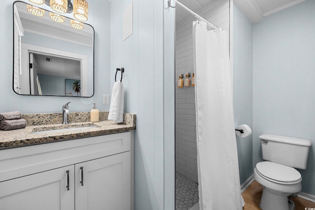 bathroom with walk in shower, ornamental molding, toilet, and vanity