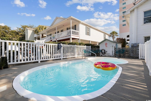 view of swimming pool with a storage unit