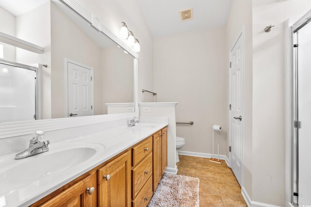 bathroom featuring vanity, a shower with shower door, toilet, and tile patterned flooring