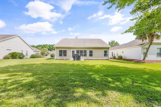 rear view of house with a lawn