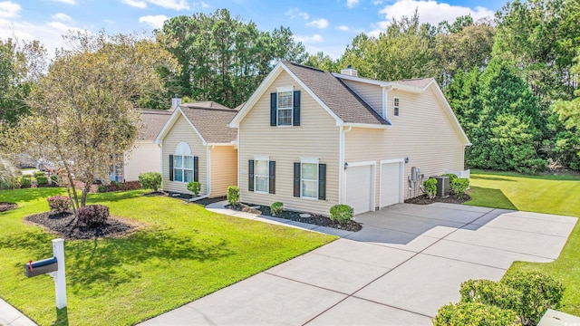 front of property with a front yard, cooling unit, and a garage