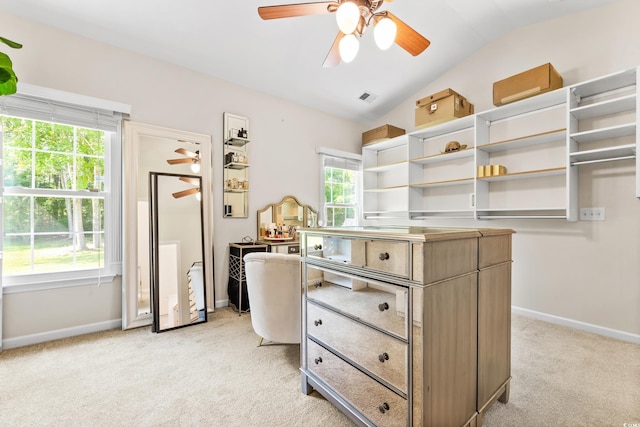 spacious closet with light carpet, lofted ceiling, and ceiling fan