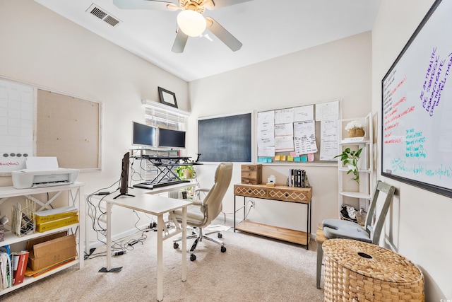 carpeted home office featuring ceiling fan