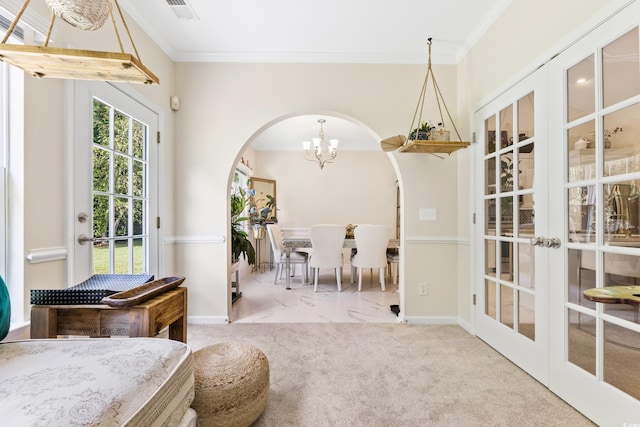 interior space featuring light colored carpet, crown molding, an inviting chandelier, and french doors