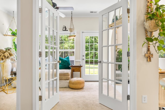 entryway featuring ceiling fan, light carpet, french doors, and plenty of natural light