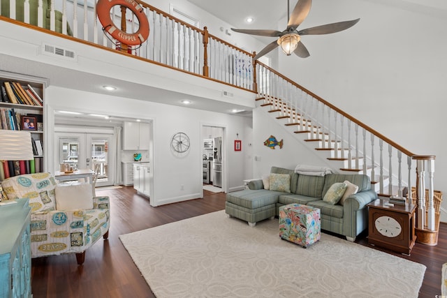 living room featuring french doors, ceiling fan, dark hardwood / wood-style flooring, and a high ceiling