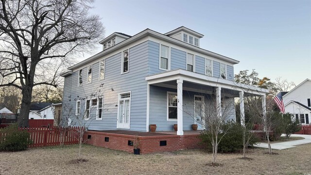 view of front facade with a balcony and a front yard