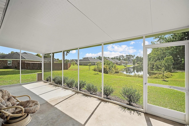 unfurnished sunroom with a water view